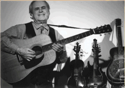 Texas a la Moag - Picture Of Rod Moag with lots of guitars and mandolins